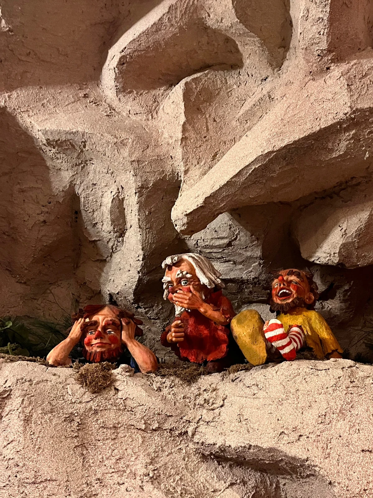 Three troll statues inside the Grottenbahn fairy-tale cave in Linz